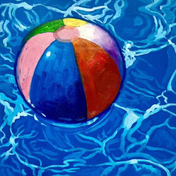 Beach ball floating on pool
