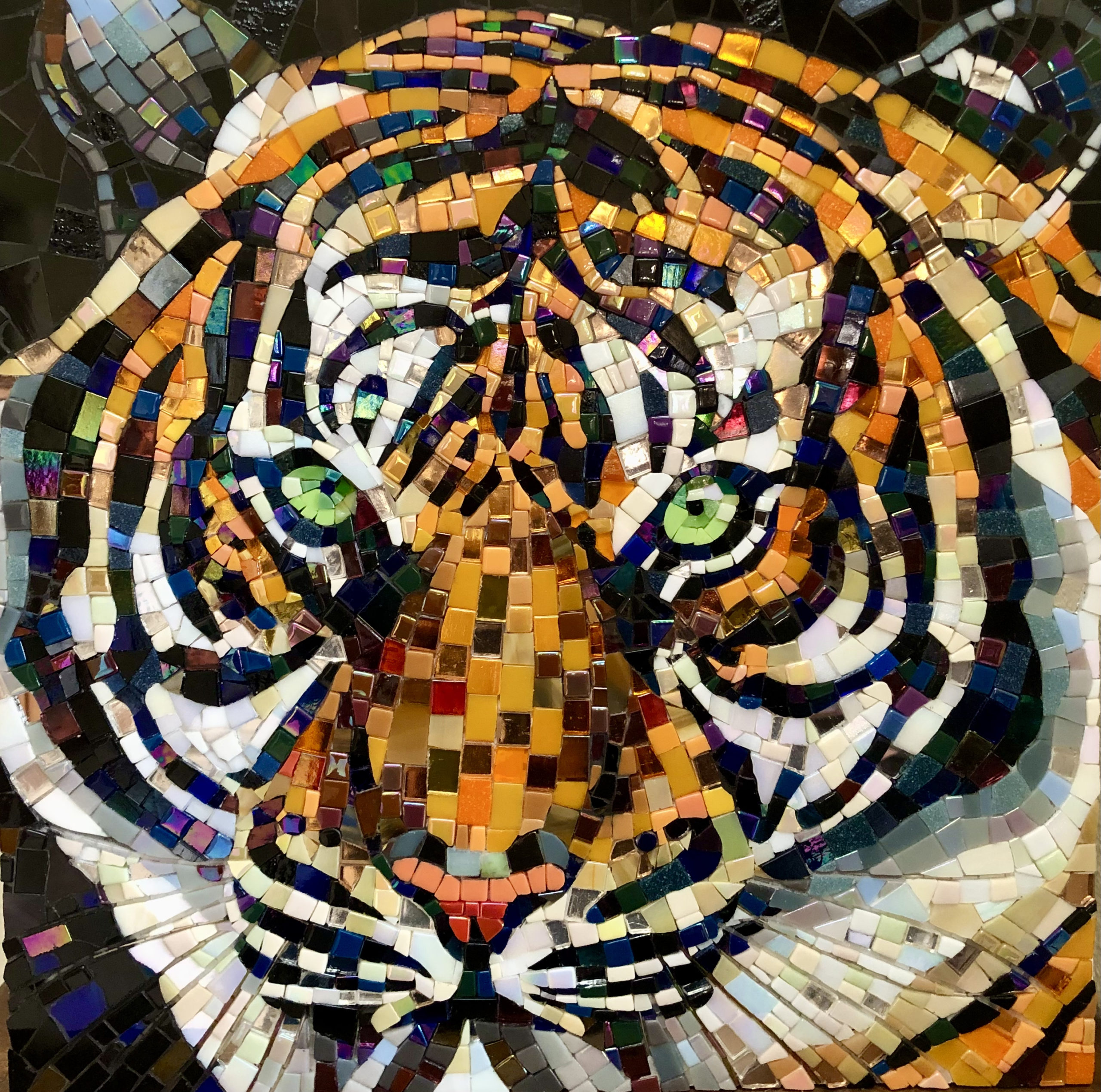 A glass mosaic of a tiger with bright green eyes
